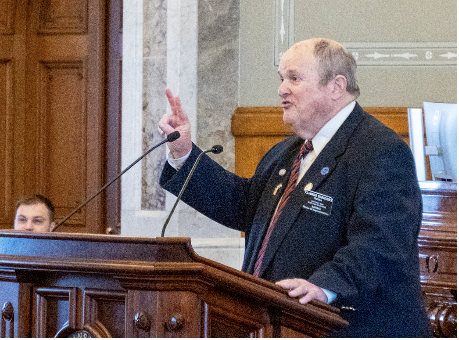 Rep. Clarke Sanders, R-Salina, won't appear on the November ballot after the Kansas secretary of state granted his request to withdraw. He is the second Republican nominee to step aside from the general election due to health issues. GOP nominee Cody Ward withdrew in the 110th District of the Kansas House. This is a March 19, 2025, image of Sanders speaking on the Kansas House floor. (Photo by Sherman Smith/Kansas Reflector)