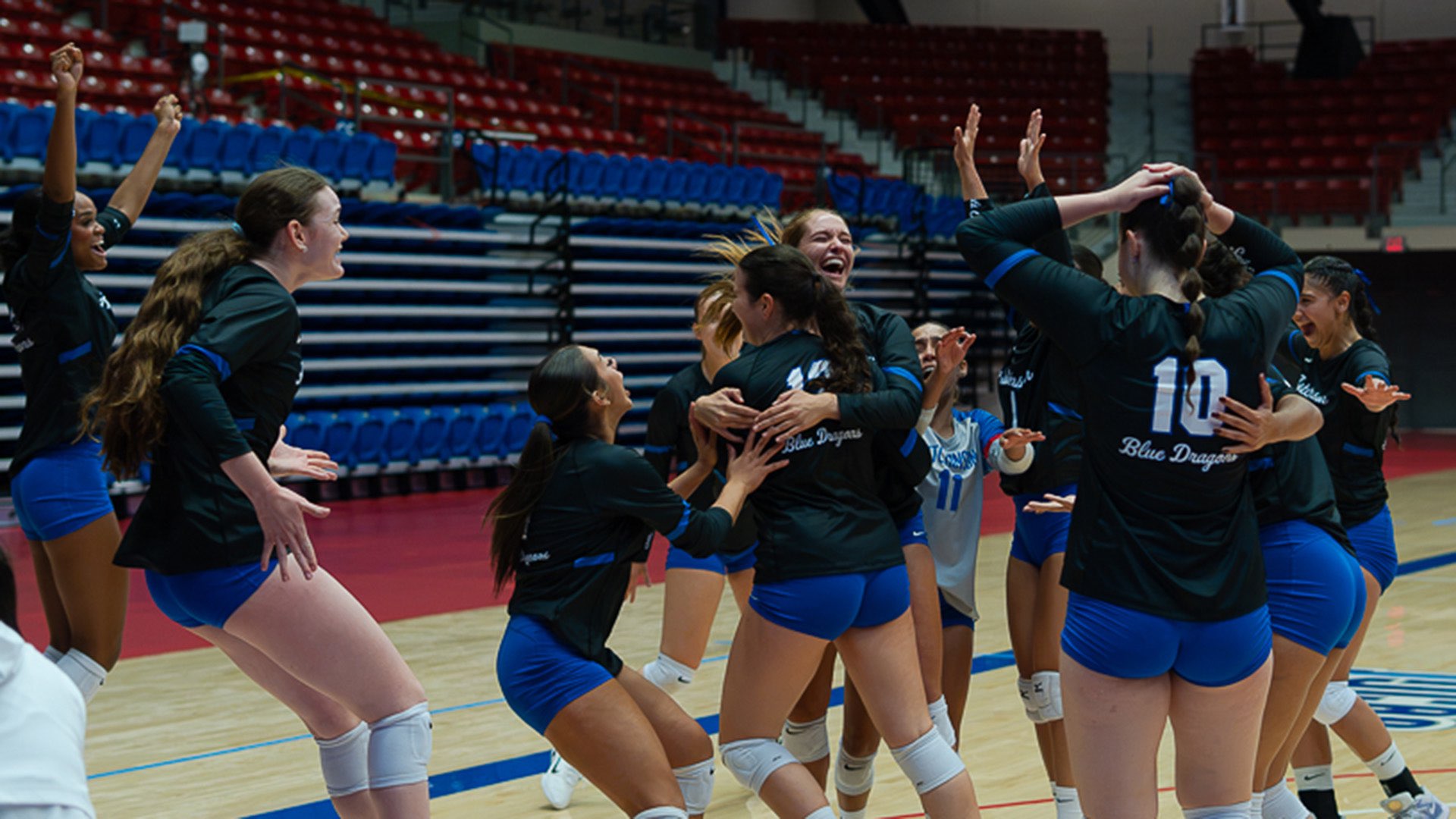Teammates mob Blue Dragon freshman setter Luisa Richa after her ace serve on match point clinched a 3-1 victory over No. 15 Indian Hills in the opening match of the 2026 Blue Dragon Volleyball Classic on Thursday at the Sports Arena. (Abby Filippi/Blue Dragon Sports Information)