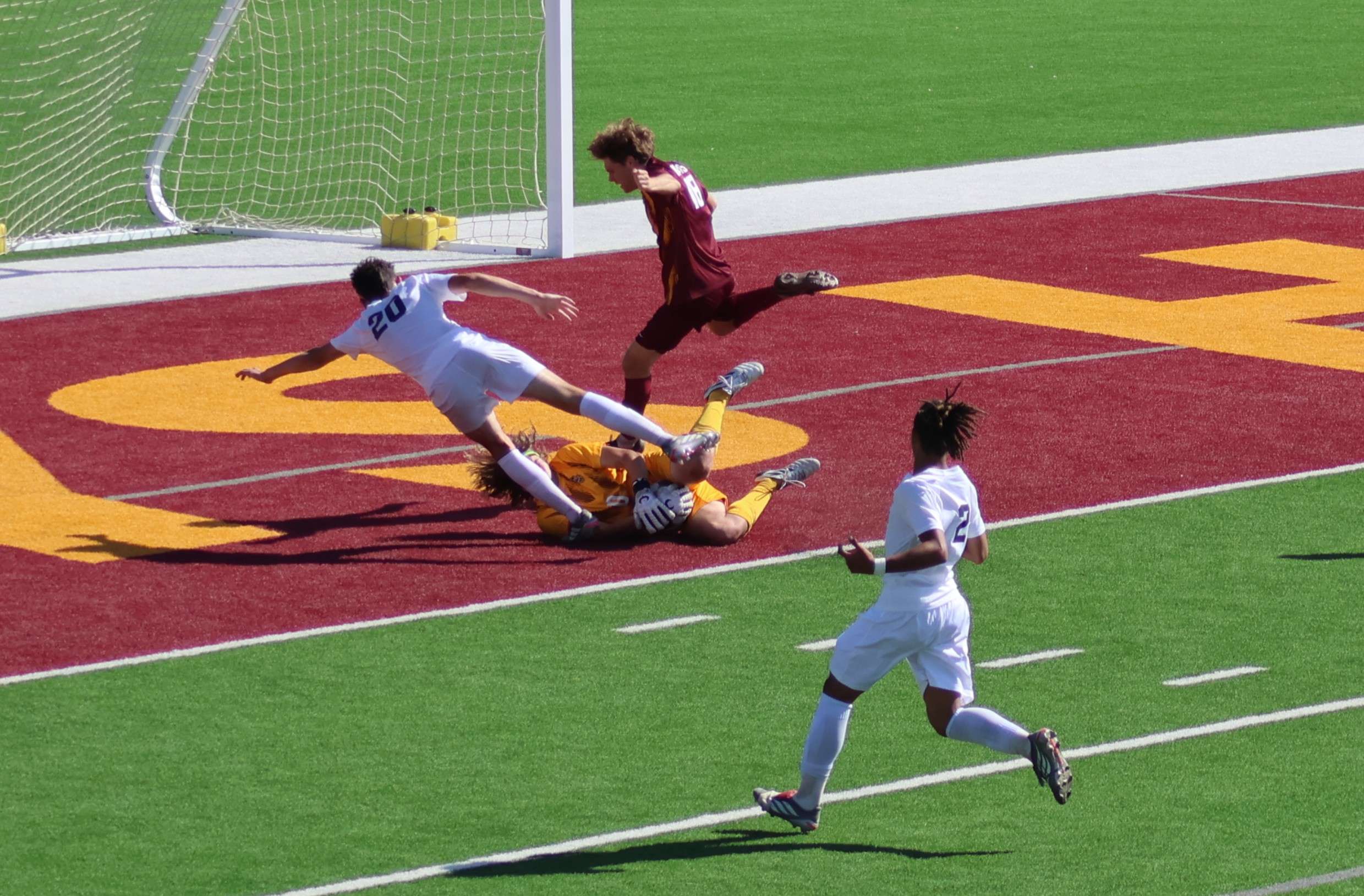 Hays High senior goalkeeper Cedric Durr secures the ball - and the shutout - Thursday in a collision with Wichita East senior Eliot Hill as Indian sophomore Ryus Custer also defends. Courtesy photo