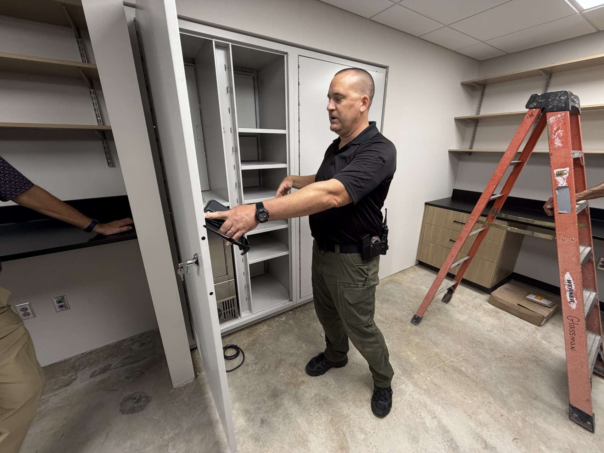 Investigator Aaron Larson shows the rear entry of evidence transfer lockers.&nbsp;Photo by Becky Kiser/Hays Post