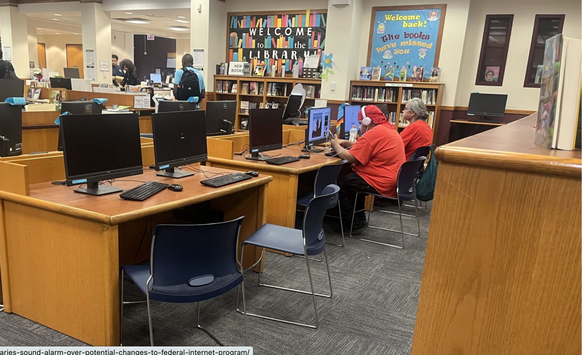  Patrons use free Wi-Fi at a public library in Chicago. For nearly 30 years, the E-Rate program has helped connect schools and libraries to the internet, but the Trump administration is reviewing the program. (Photo Robbie Sequeira/Stateline)