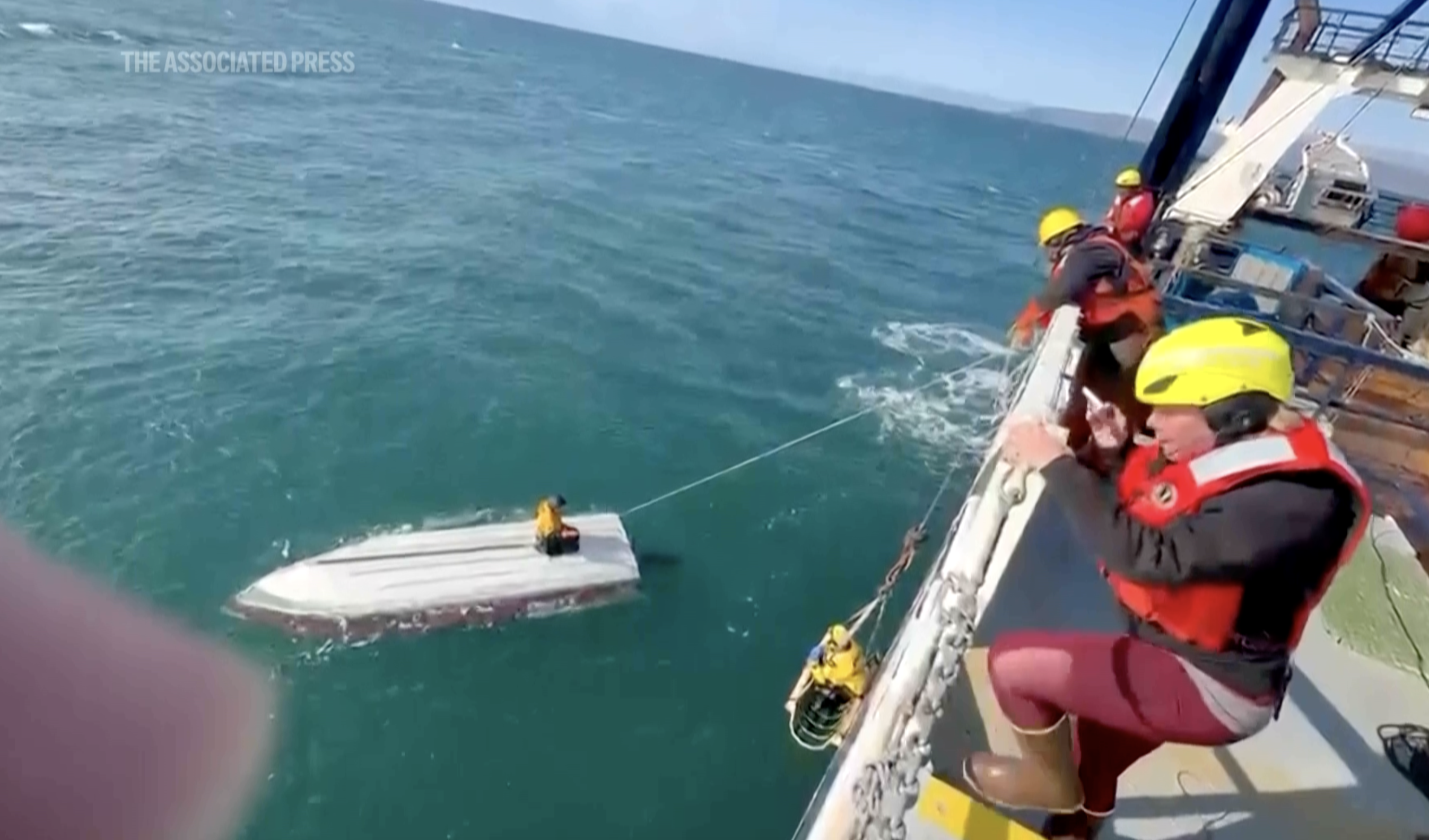 This image taken from video provided by Carlos Alexis Escartin shows a teenager being rescued by a fishing vessel Monday, Sept. 7, 2026, in the Bering Sea near St. Lawrence Island, Alaska. (Carlos Alexis Escartin via AP)