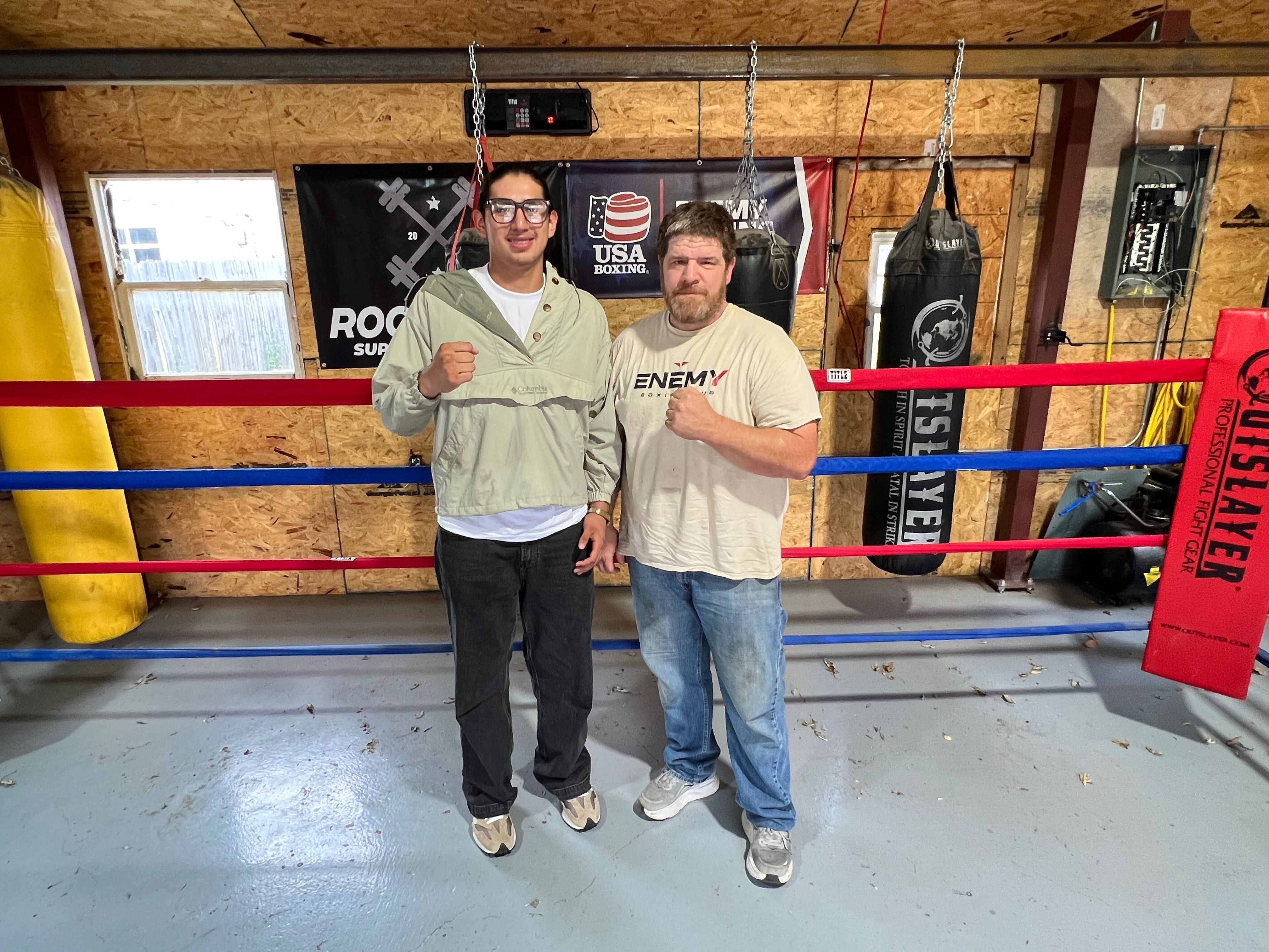 Angel Blancarte, left, and Enemy Boxing Club head coach Richard Gadbury pose for a photo Wednesday, Sept. 9, 2026, at Enemy Boxing Club in Hutchinson, Kansas. Blancarte is preparing to represent the United States in international competition in Montenegro. (Hutch Post Photo/Sean Boston)<br>