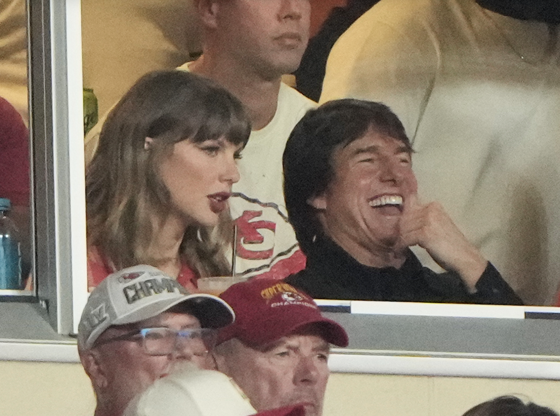 Taylor Swift, left, sits with Tom Cruise, center, while watching the first half of an NFL football game between the Kansas City Chiefs and the Denver Broncos, Monday, Sept. 14, 2026, in Kansas City, Mo. (AP Photo/Charlie Riedel)