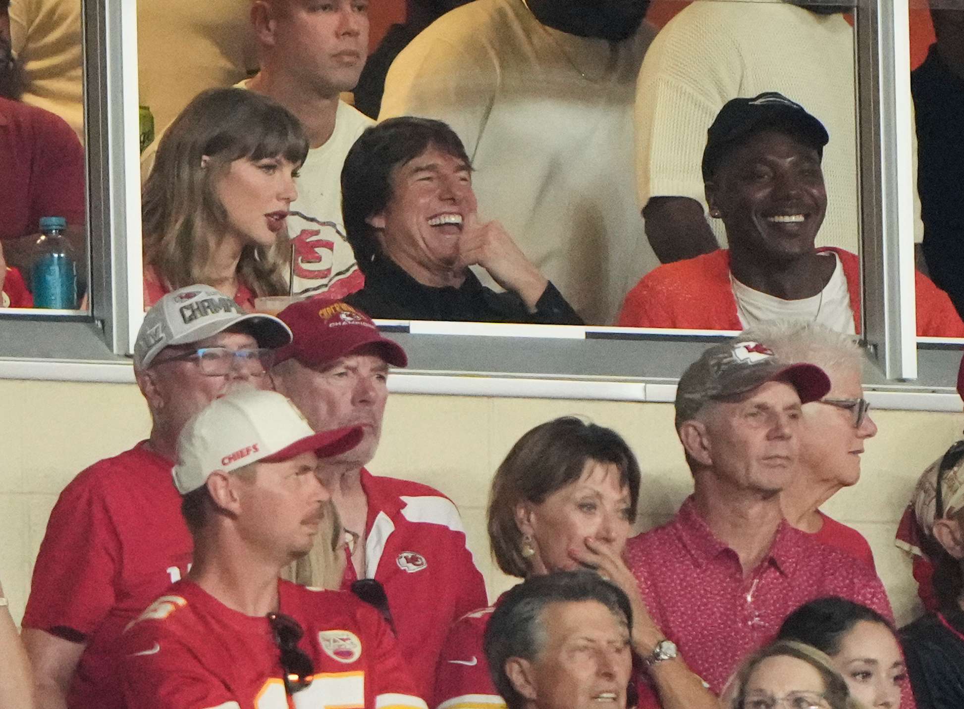 Taylor Swift, left, sits with Tom Cruise, center, while watching the first half of an NFL football game between the Kansas City Chiefs and the Denver Broncos, Monday, Sept. 14, 2026, in Kansas City, Mo. (AP Photo/Charlie Riedel)