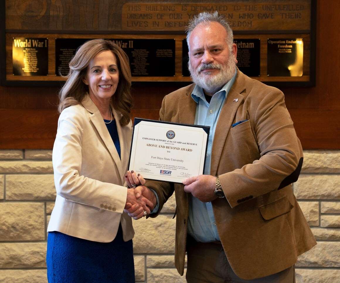 Fort Hays State University President Tisa Mason accepts the Above and Beyond award from Joe Leroux, ESGR military outreach coordinator. Photo courtesy FHSU