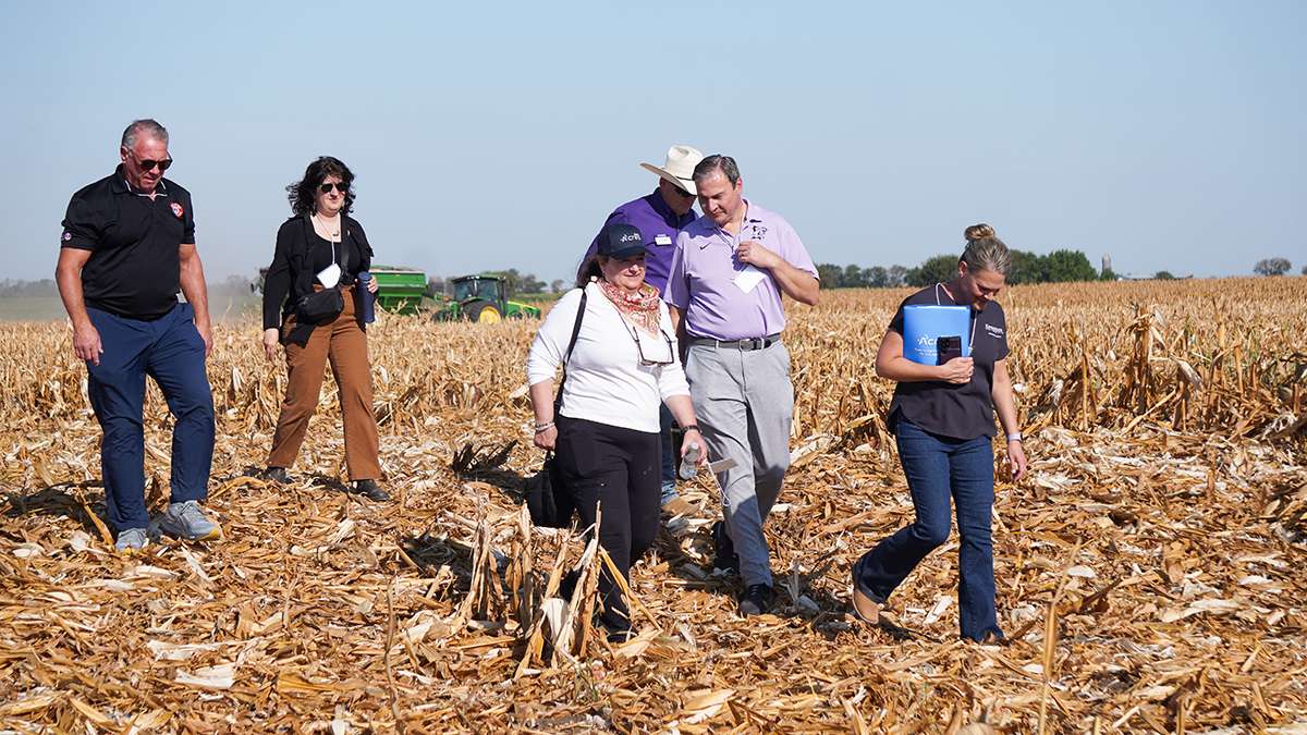 Karen St. Germain, director of NASA's Earth Science division, in white, walks with K-State Vice President for Research Hans Coetzee at the Flickner Innovation Farm. (Courtesy K-State Research and Extension)