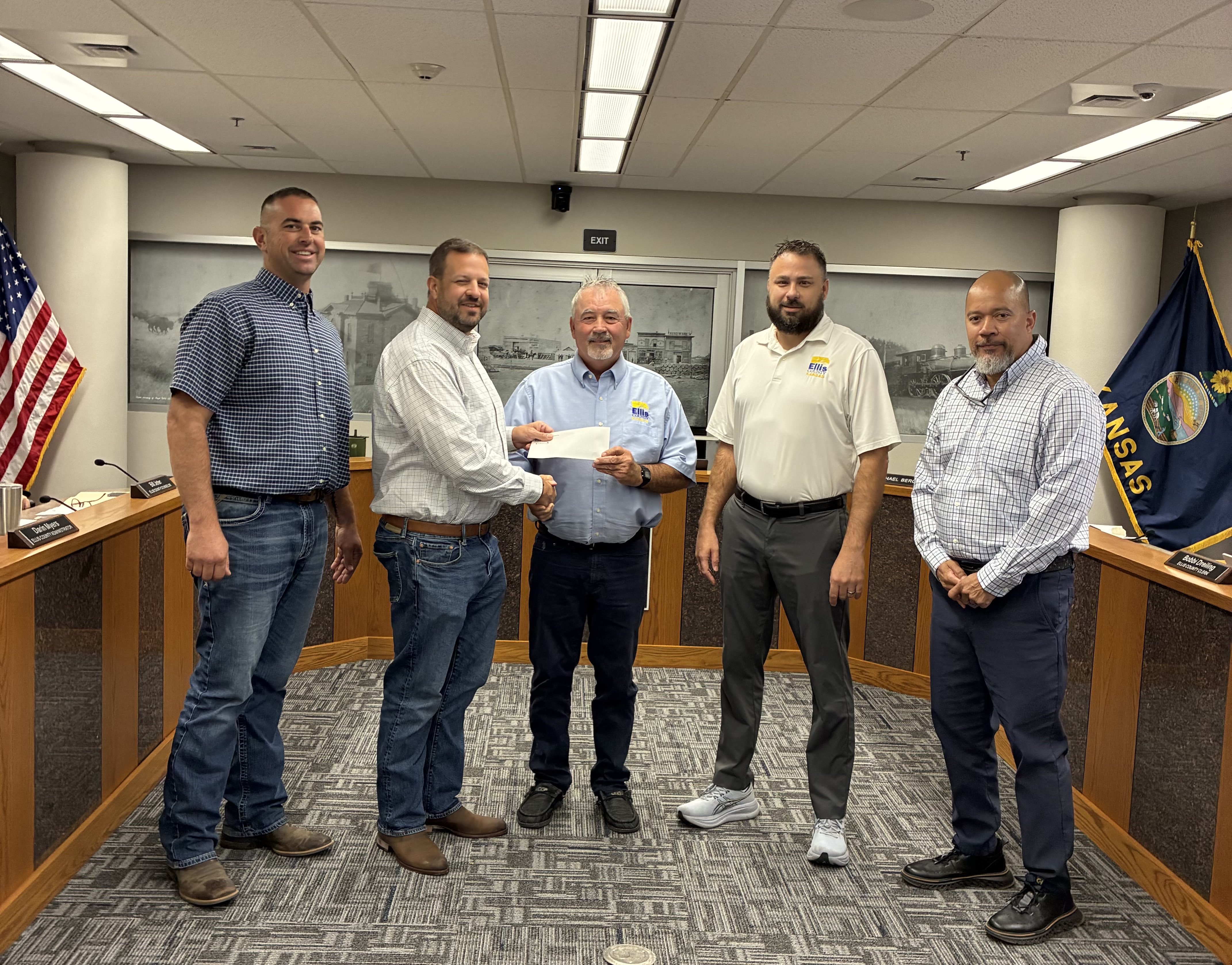 Ellis County commissioners receive a check for $200,000 from Tallgrass Development LLC. to upgrade the Fairgrounds lighting. From left: Commissioner Nathan Leiker, CEO of ibV and Tallgrass development Chris McKissack, Commissioner Neal Younger, Commissioner Michael Burgess and Project Developmer Steve Link. Photo by Alin Hett/Hays Post&nbsp;
