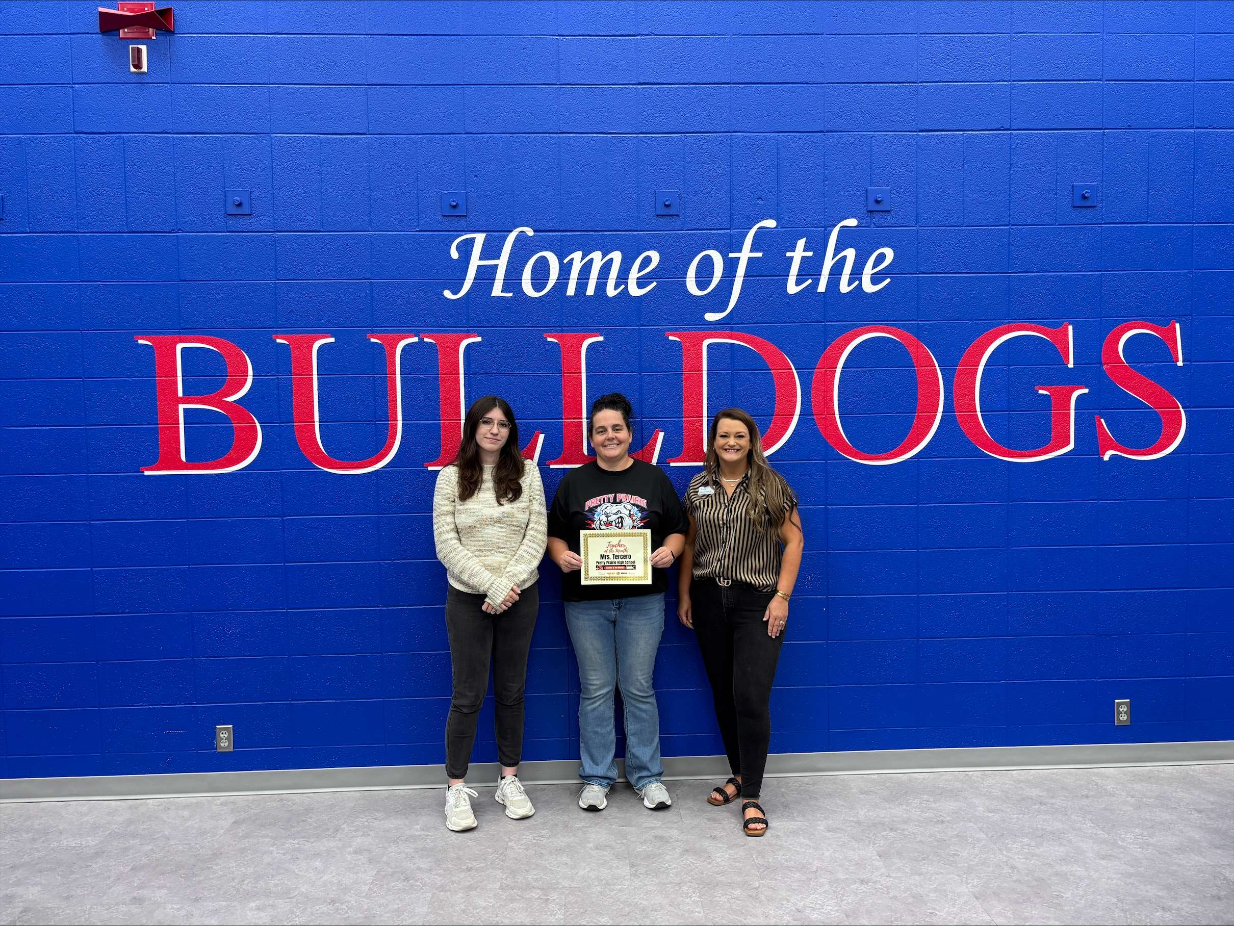 Pretty Prairie teacher Jessica Tercero, center, poses with Rylee of PrairieStar Health Center, left, and Ashley Weve of Eagle Media after Tercero was presented with the September Teacher of the Month award. (Hutch Post Photo)