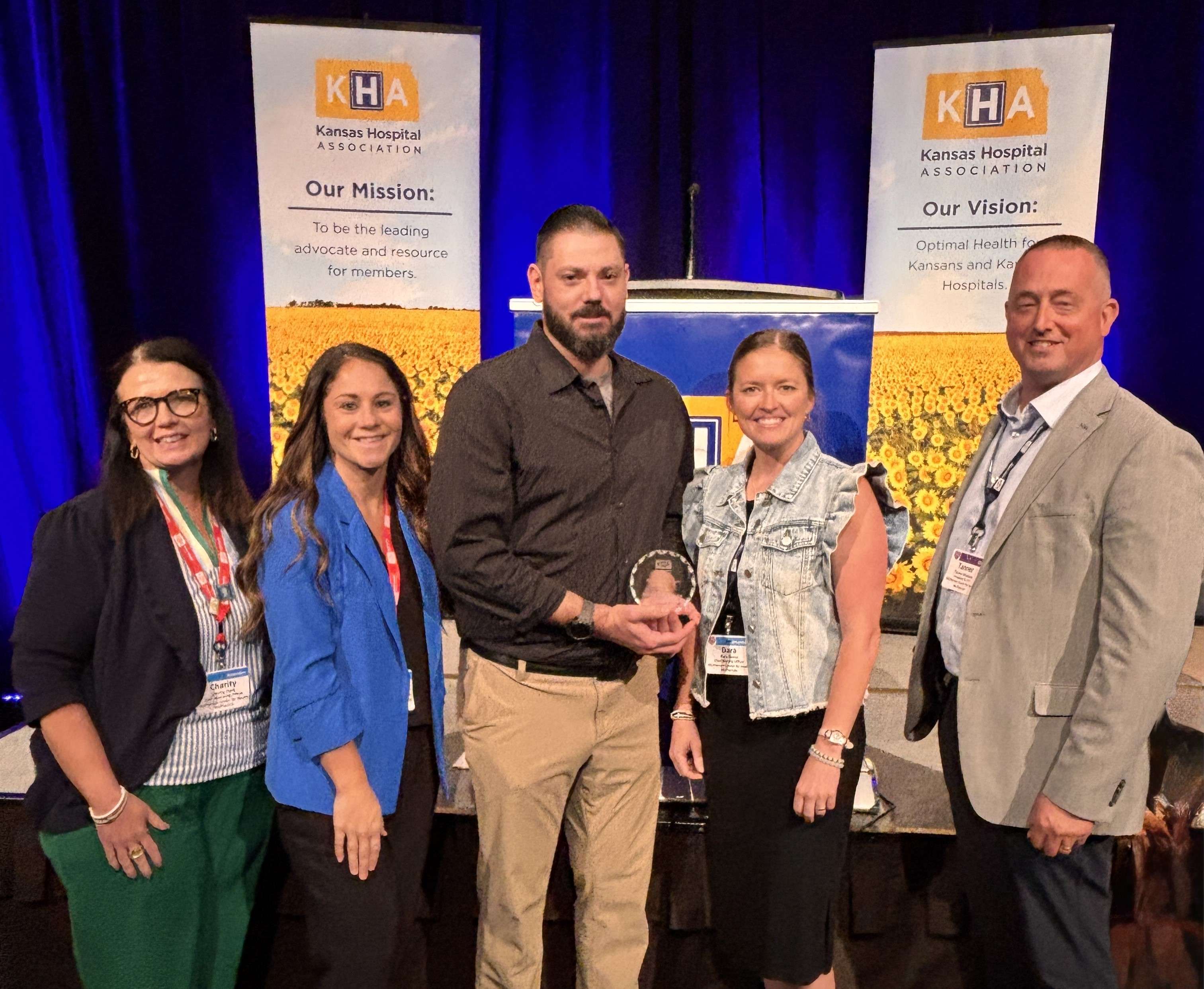 Pictured from left are McPherson Center for Health representatives Charity Clark, Chief Operating Officer; Carol Fickes, Chief of Provider and Clinic Operations; Jacob “Jake” Perryman, APRN; Dara Reese, Chief Nursing Officer; and Tanner Wealand, President and CEO. Perryman received the Kansas Hospital Association Heart of Health Care Award during the KHA Convention and Trade Show in Overland Park.