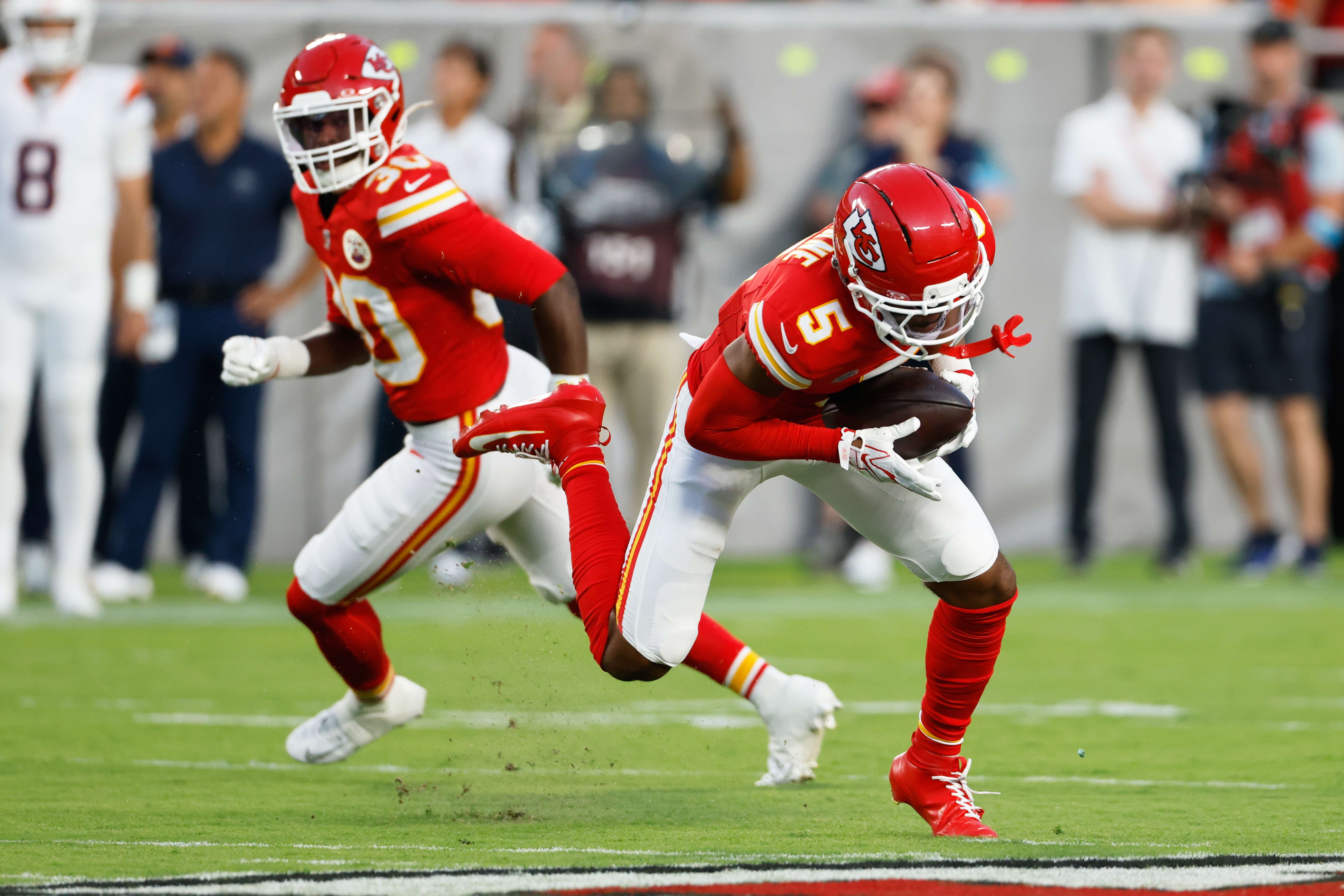 Kansas City Chiefs cornerback Mansoor Delane (5), with teammate cornerback Christian Roland-Wallace (30) looking, intercepts a pass by Denver Broncos quarterback Bo Nix, not visible, during the first half of an NFL football game Monday, Sept. 14, 2026, in Kansas City, Mo. (AP Photo/Colin E. Braley)
