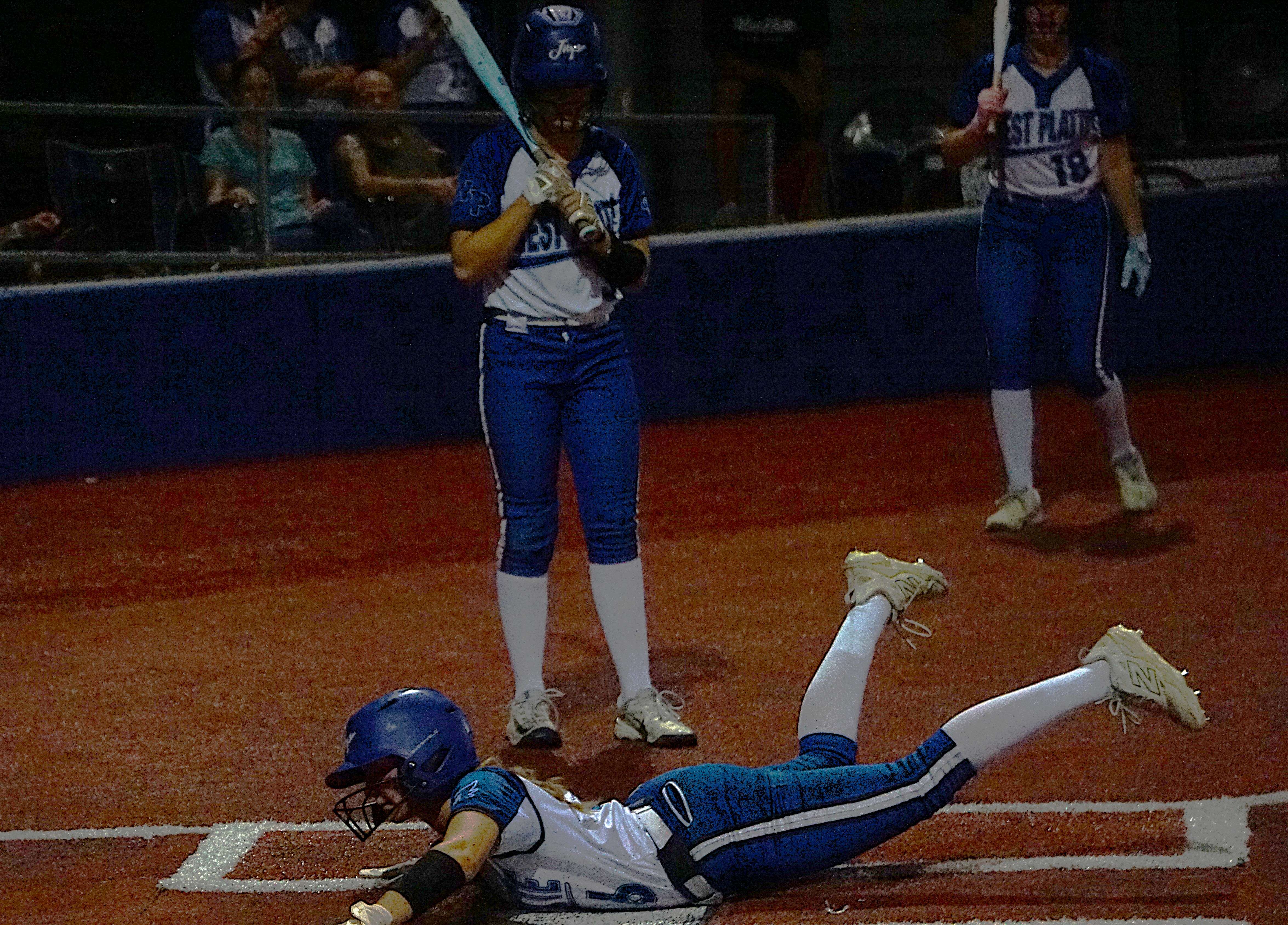 West Platte's Vaida Vasques slides across home scoring on a wild pitch/ Photo by Matt Pike