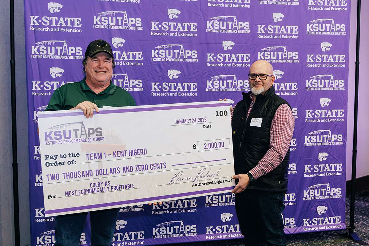 Kent Higerd, farmer and two-time winner of K-State's TAPS competition, receives his award at the 2026 TAPS awards banquet with Dean Krehbiel, state resource conservationist for Kansas. Photo courtesy K-State Research and Extension