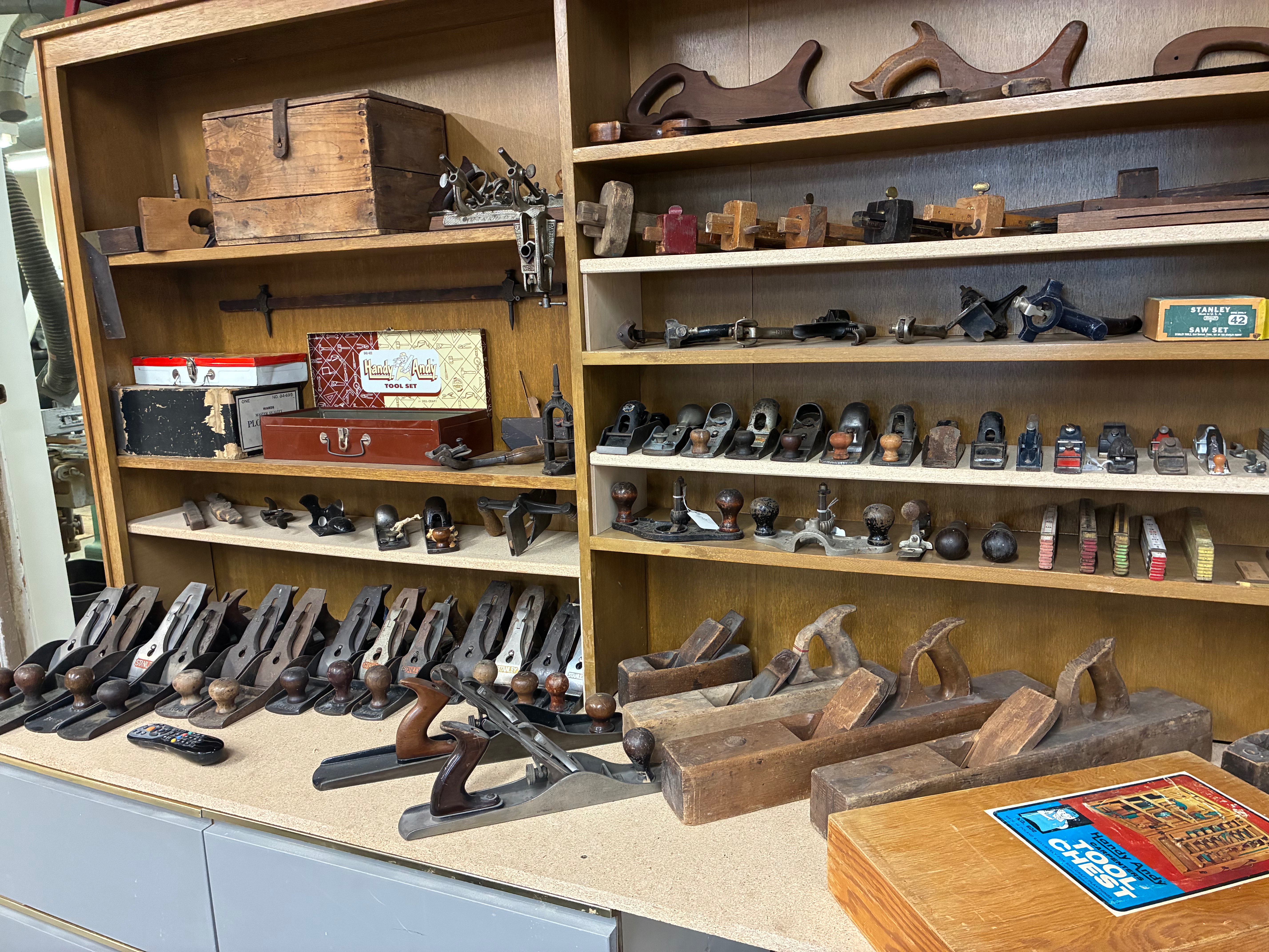 a collection of antique hand planes used to shape and smooth wood.<br>