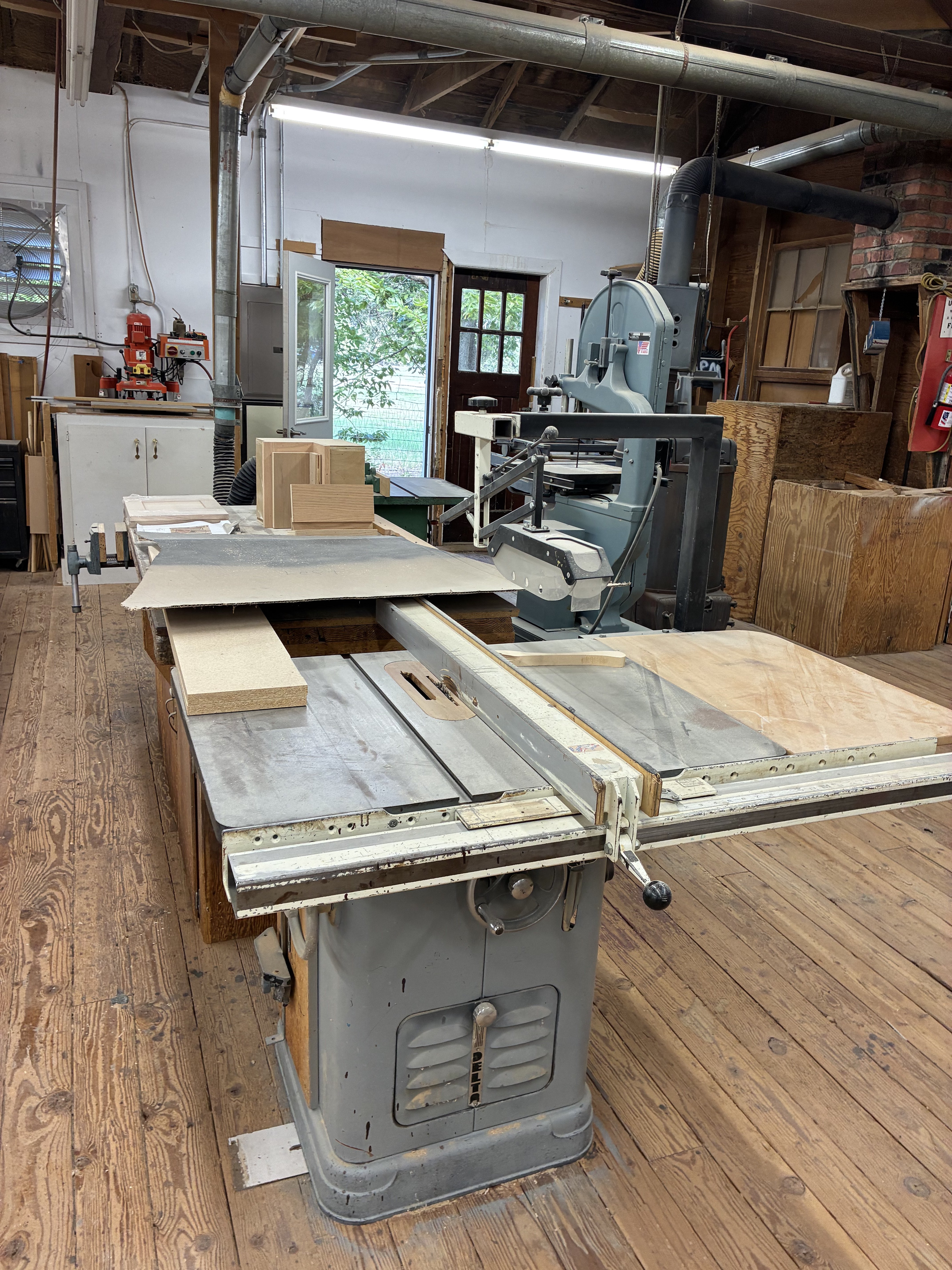 Woodworking equipment, including a table saw and band saw, fills the Hays Planing Mill workshop.<br>