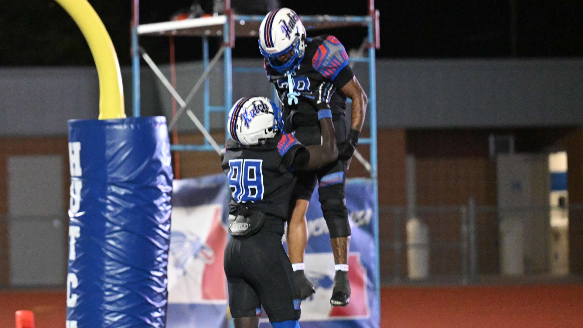 Blue Dragon running back Terrell King (28) is congratulated by teammate Terence Johnson after scoring his first career touchdown last Saturday against Garden City. King, Johnson and the No. 2 Blue Dragons travel to play No. 12 Butler at 6 p.m. on Saturday in El Dorado. (Andrew Carpenter/Digital Fox Photography).
