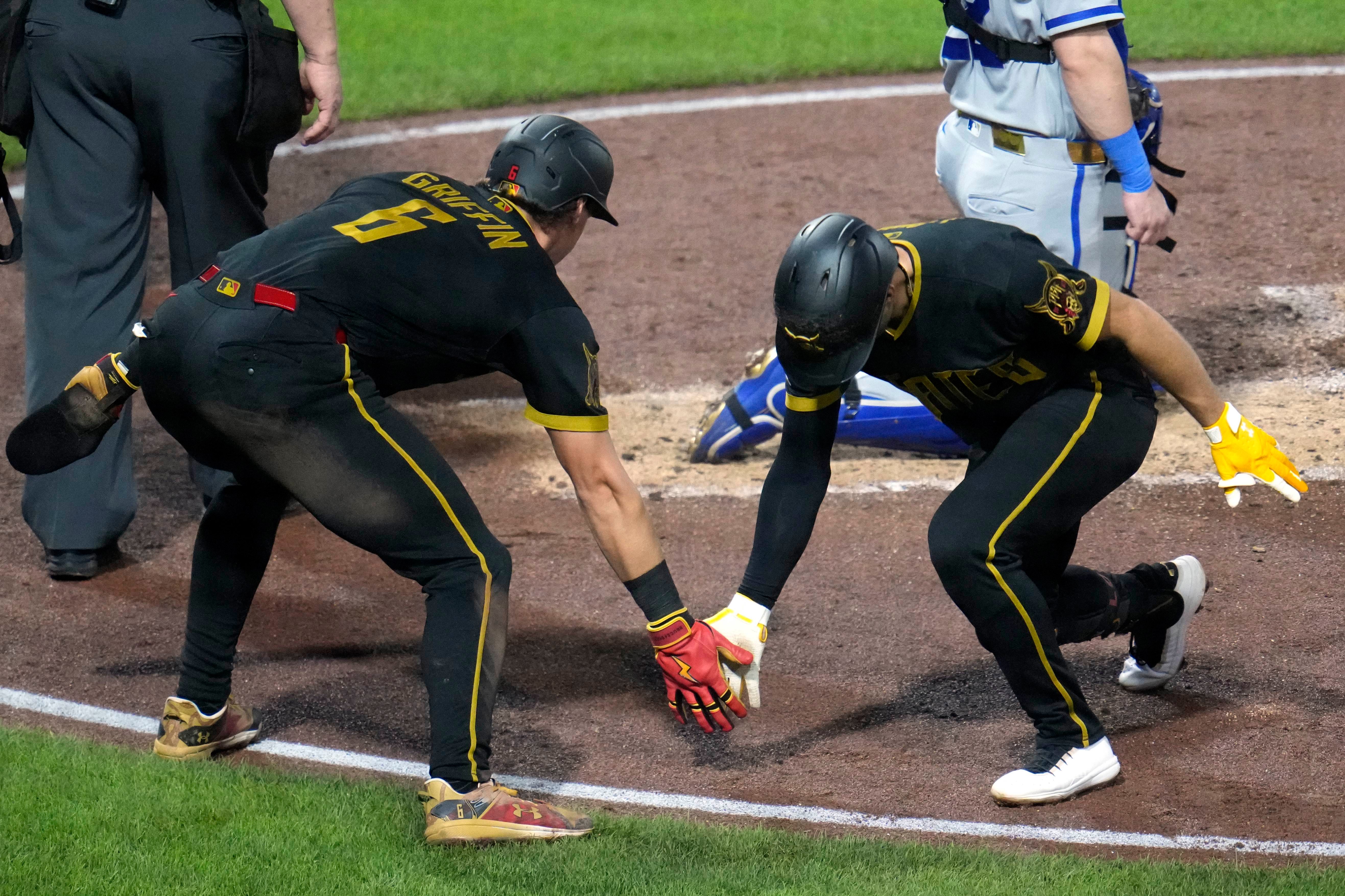 Pittsburgh Pirates' Brandon Lowe, right, celebrates with Konnor Griffin (6) after hitting a two-run home run off Kansas City Royals pitcher Randy Dobnak during the third inning of a baseball game in Pittsburgh, Friday, Sept. 18, 2026. (AP Photo/Gene J. Puskar)