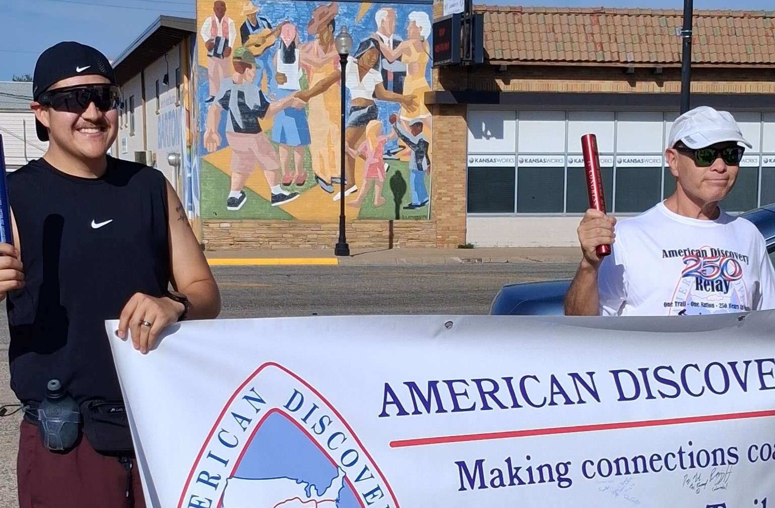 Great Bend's Erick Alcala (left) and Chris Saenz carried the baton approximately seven miles for the America 250 Relay that passed through Pawnee and Barton counties Saturday. (photo courtesy of Roxie Edwards)