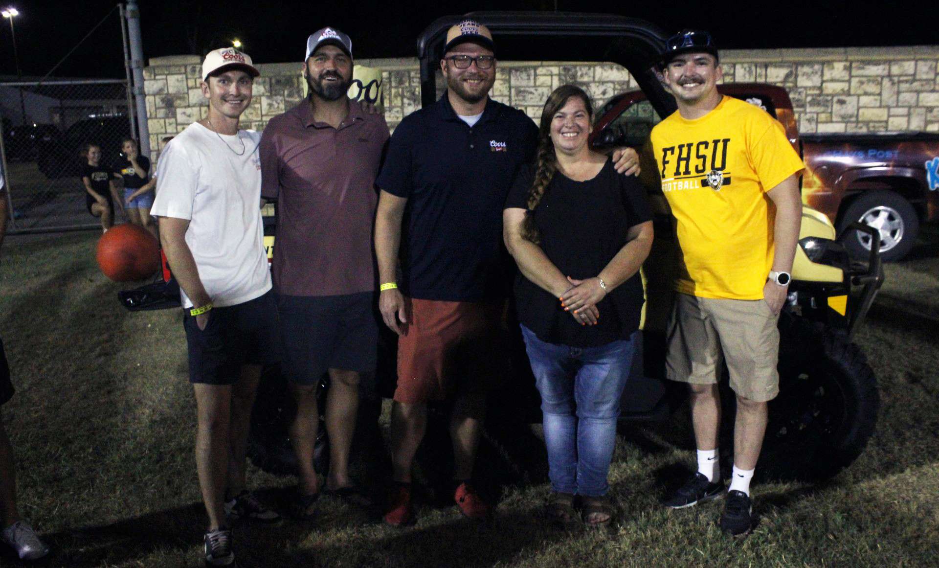 Wendy Still of Ellis, center, was named he winner of the&nbsp;Coors Banquet CAN AM UTV Saturday night at the Fort Hays State University football game. Photo by Cristina Janney/Hays Post