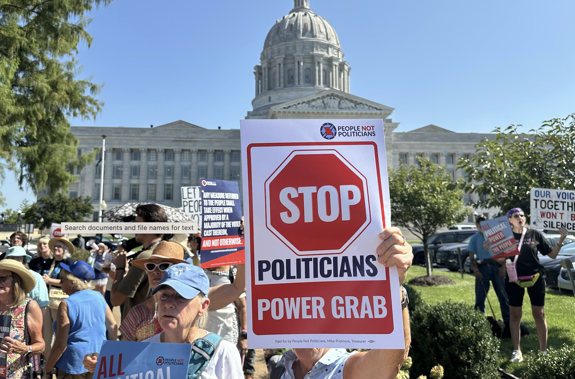 In this photo taken with a smartphone, people opposed to a congressional redistricting plan rally outside the Missouri Capitol in Jefferson City, Mo., Wednesday, Sept. 2, 2026. (AP Photo/David A. Lieb)