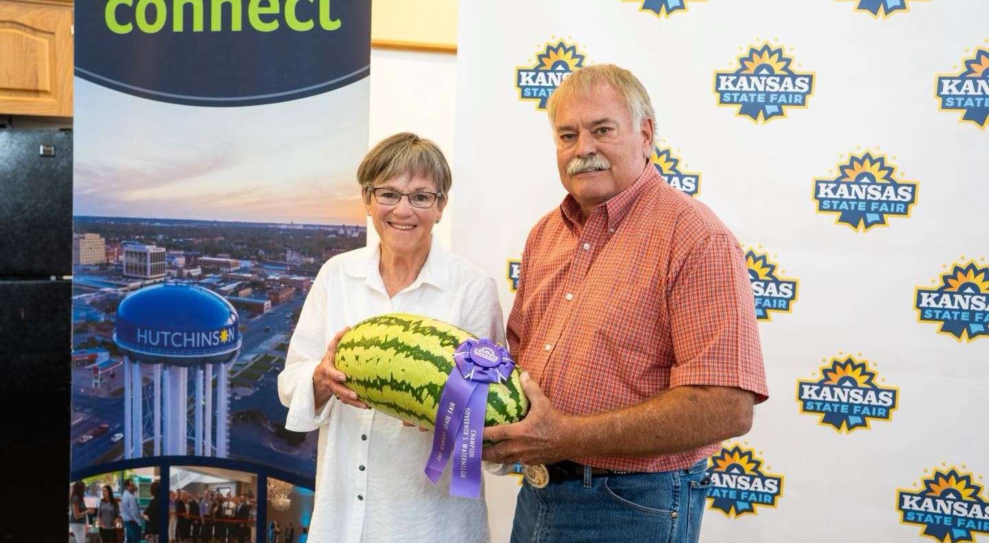 Ellinwood's Wayne DeWerff hands Kansas Governor Laura Kelly a watermelon after winning his fourth Governor's Sweepstakes in the last six years at the Kansas State Fair. (photo courtesy of Gov. Kelly's Facebook page)