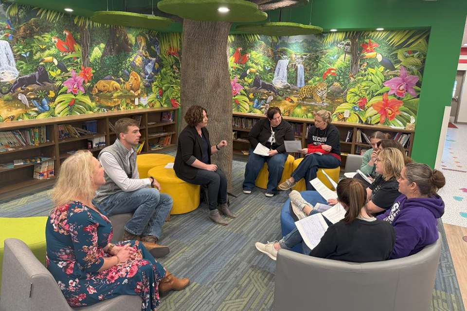 Members of a K-State research team meet with elementary school teachers at the Logan Intergenerational Family Education Center as they kick off a study of the center's benefits.