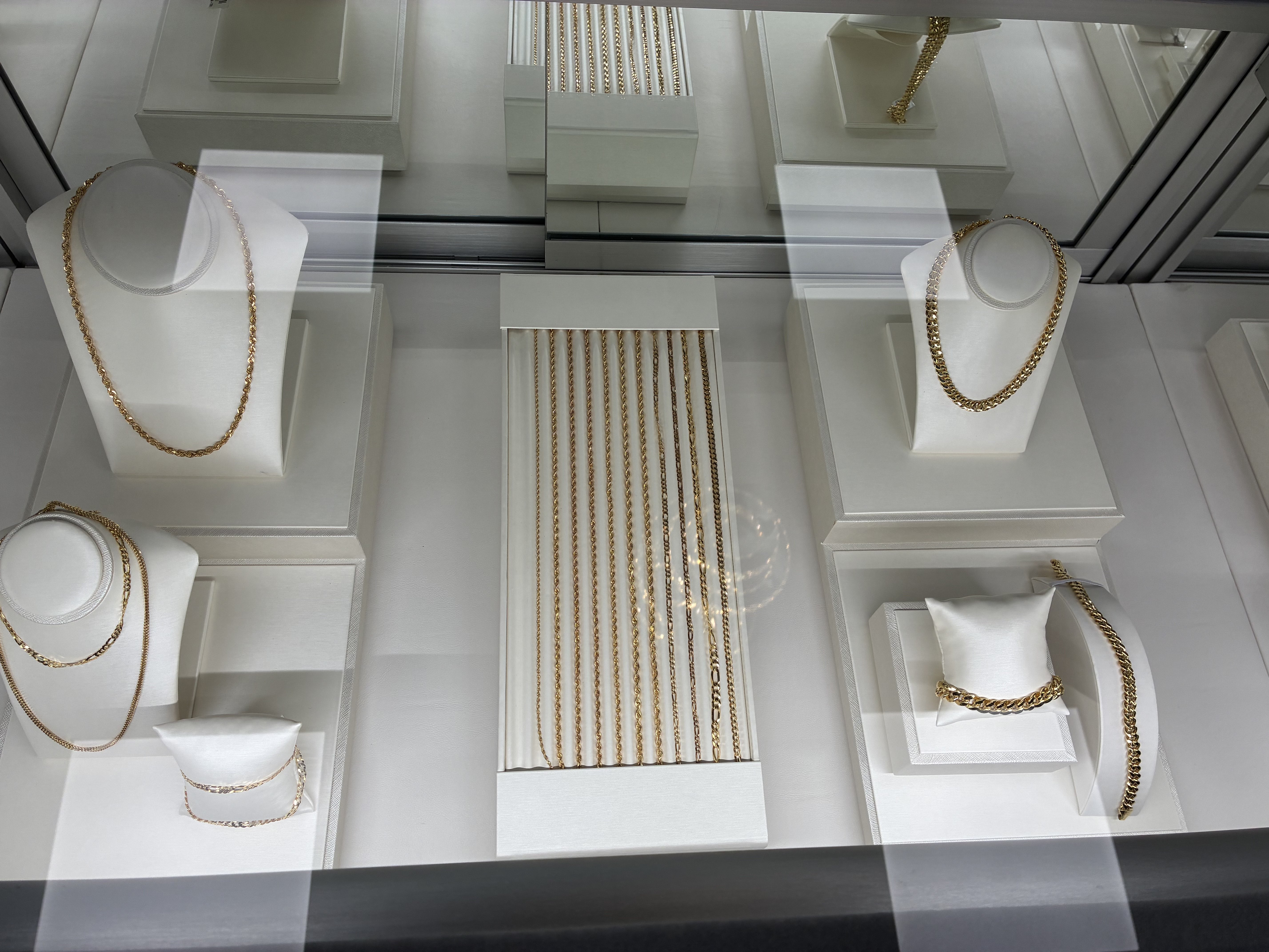 Gold necklaces, chains, and bracelets are displayed in a case at the jewelry store’s new location in Hays. Photo by Alin Hett/Hays Post<br>