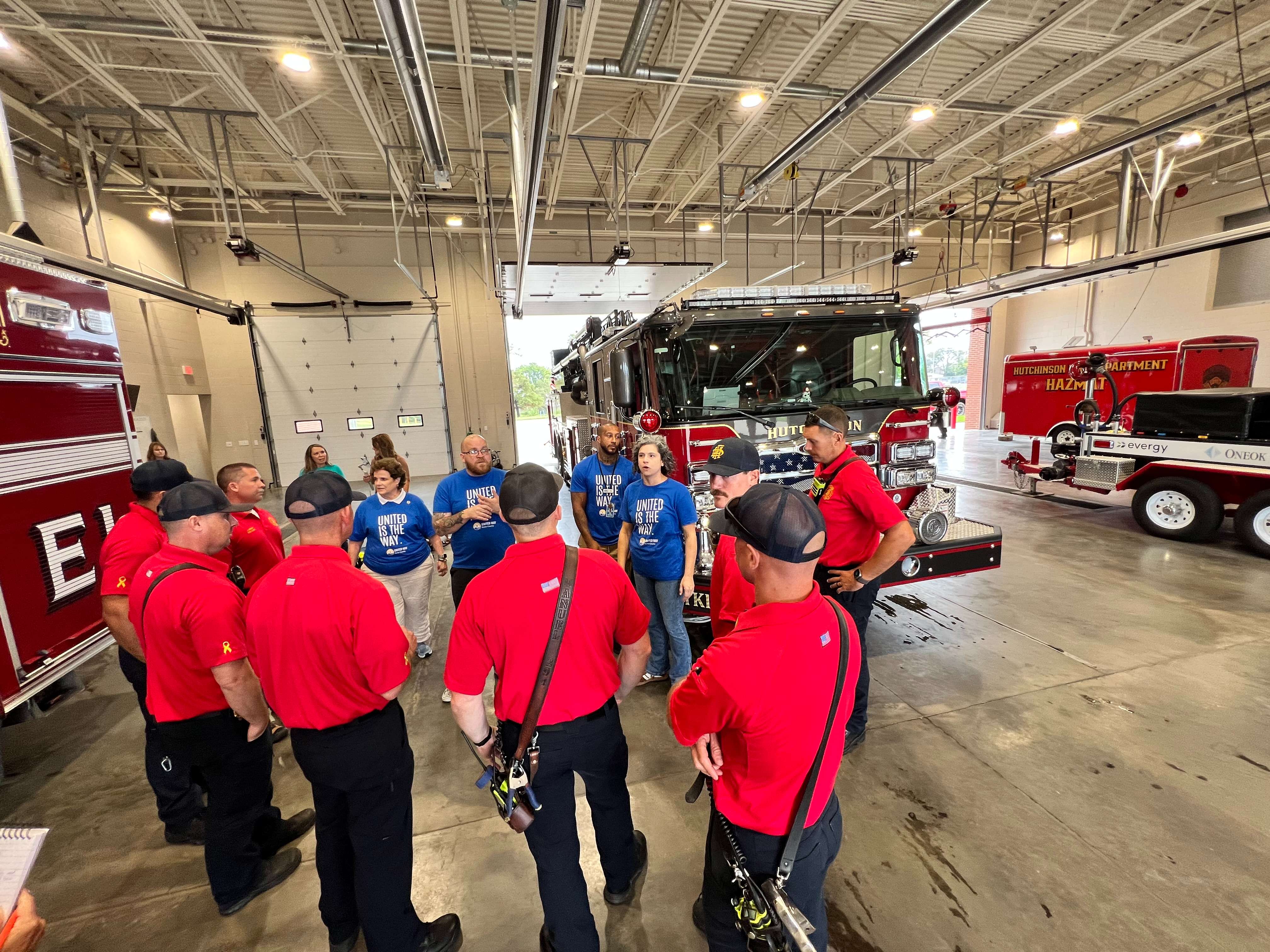 United Way of Reno County Development Manager Carla Stanfield, center, speaks with Hutchinson Fire Department personnel Friday, Sept. 25, 2026, at Fire Station No. 1. Stanfield thanked firefighters for their support and discussed the department’s new partnership with United Way to distribute books from the Dolly Parton Imagination Library to children in the community. (Hutch Post Photo/Sean Boston)