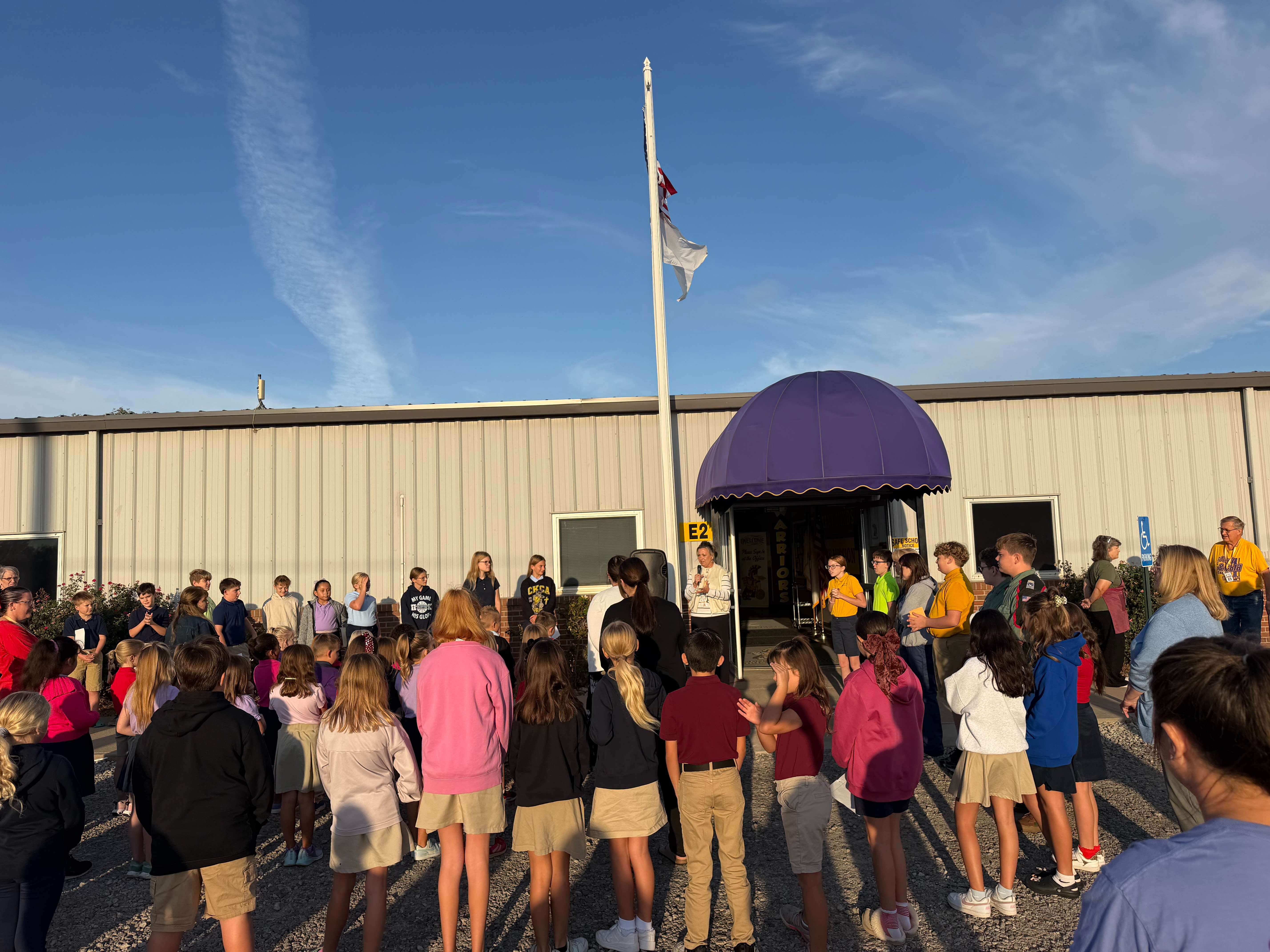 More than 90 students, staff, parents, grandparents and community members gather around the flagpole at Central Kansas Christian Academy on Sept. 23 for See You at the Pole. The prayer gathering, which included more than 60 CKCA students, was organized and led by members of the school’s Student Council.