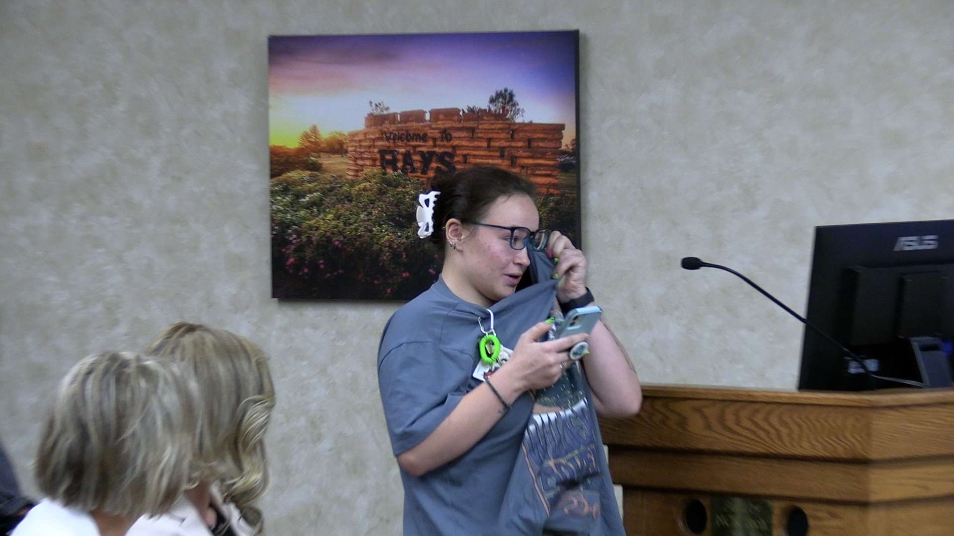 Sternberg live animal team employee Jessica Lamb wipes away a tear while she&nbsp; explains not all the animals could easily be rehomed, if the museum closes. State Rep. Barb Wasinger, R-Hays, and FHSU President Tisa Mason look on. Photo by Becky Kiser/Hays Post