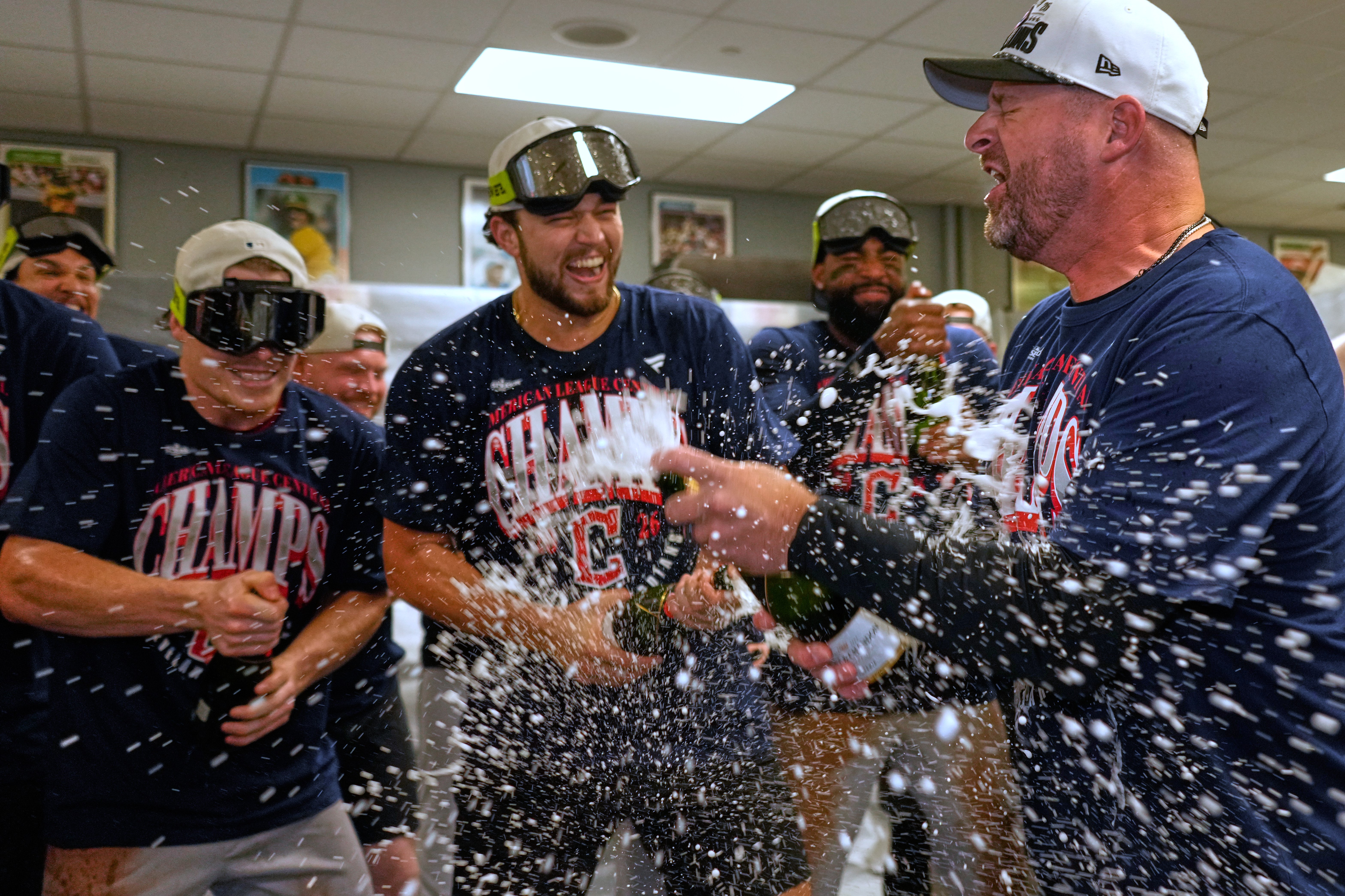Cleveland Guardians players celebrate with manager Stephen Vogt, rigtht, after clinching the American League Central division title by defeating the Kansas City Royals in a baseball game Saturday, Sept. 26, 2026, in Kansas City, Mo. (AP Photo/Charlie Riedel)