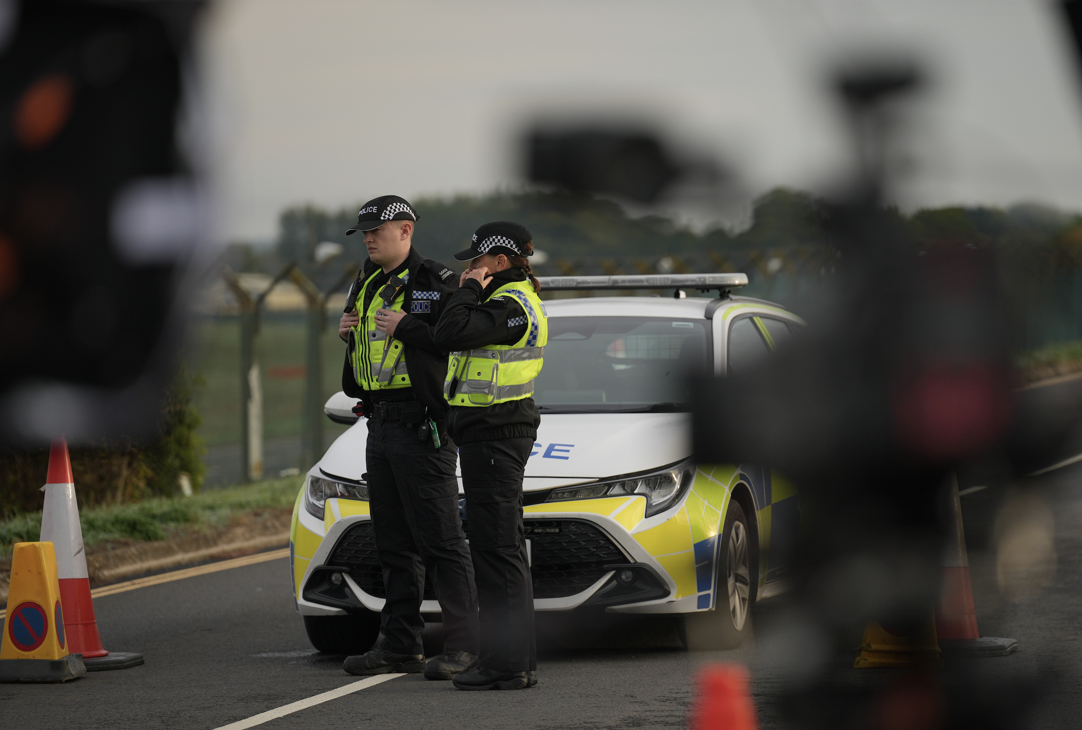 Police officers guard a road leading to RAF Fairford, after an incident in Fairford, England, Monday Sept. 28, 2026. (AP Photo/Alastair Grant)