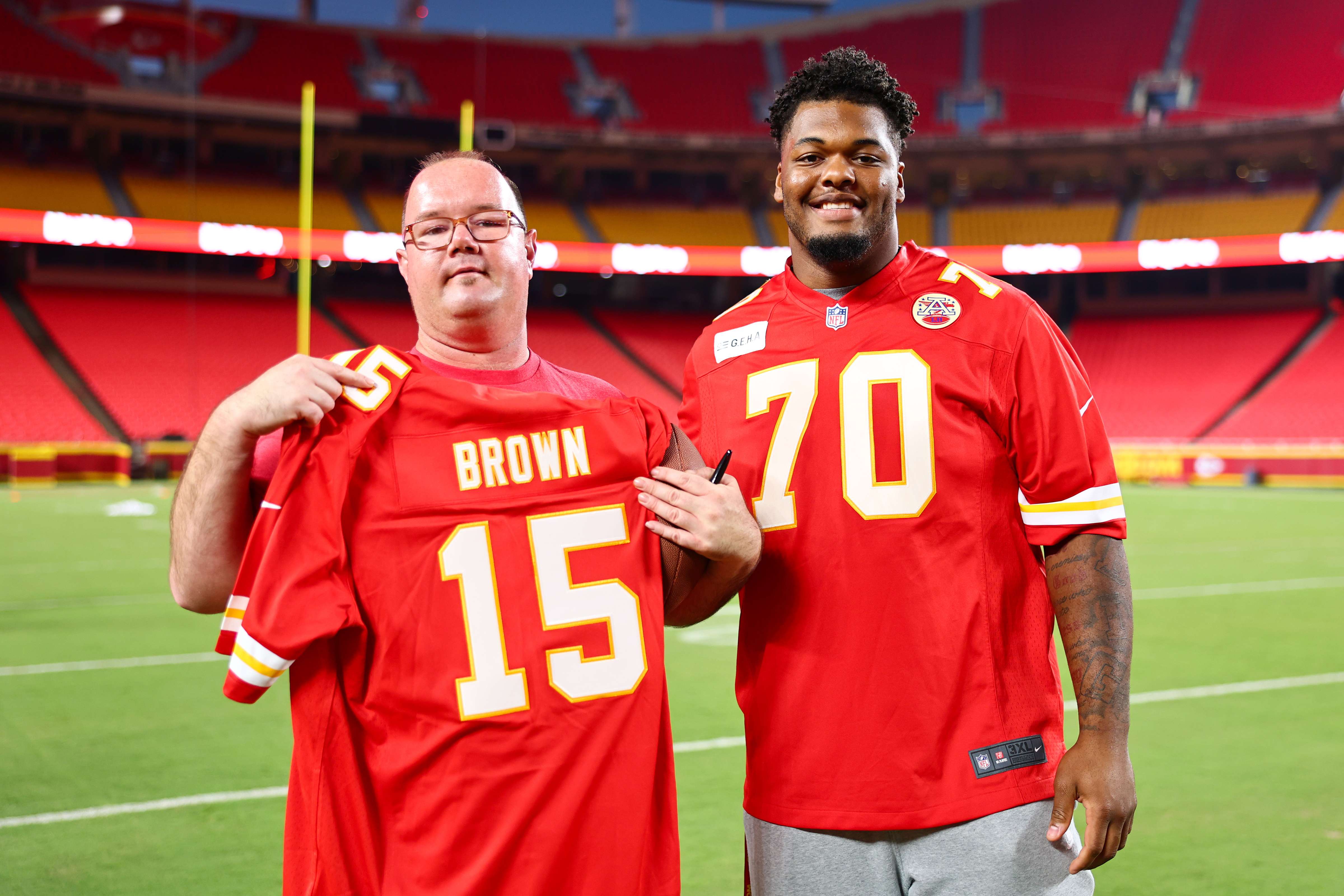 Storm Special Olympics Athlete Darren Brown holds up his NFL Chiefs Jersey while posing for a photo with Chiefs rookie offensive tackle Kahlil Benson during All Abilities Football Camp, hosted by the Kansas City Chiefs at Arrowhead Stadium on Sept. 22. (photo courtesy of Reagan Cotten, Kansas City Chiefs_