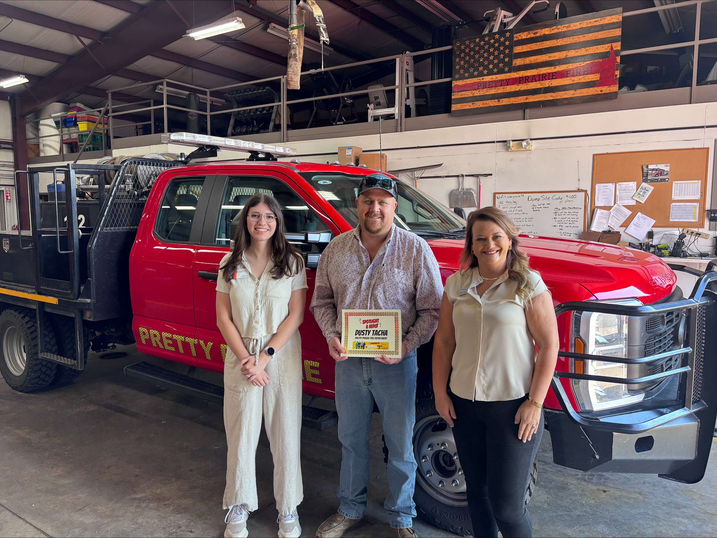 From left, PrairieStar Health Center Marketing Specialist Rylee Crist, September First Responder of the Month Dusty Tacha and Eagle Media Digital Marketing Manager Ashley Weve pose for a photo at Reno County Fire District No. 1, Station 10 in Pretty Prairie. (Hutch Post Photo)