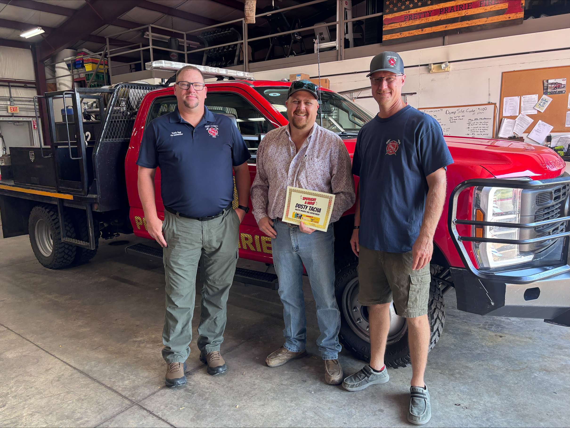 From left, Reno County Fire Administrator Travis Vogt, September First Responder of the Month Dusty Tacha and Reno County Fire District No. 1, Station 10 Chief Jake Graber pose for a photo in Pretty Prairie. (Hutch Post Photo)