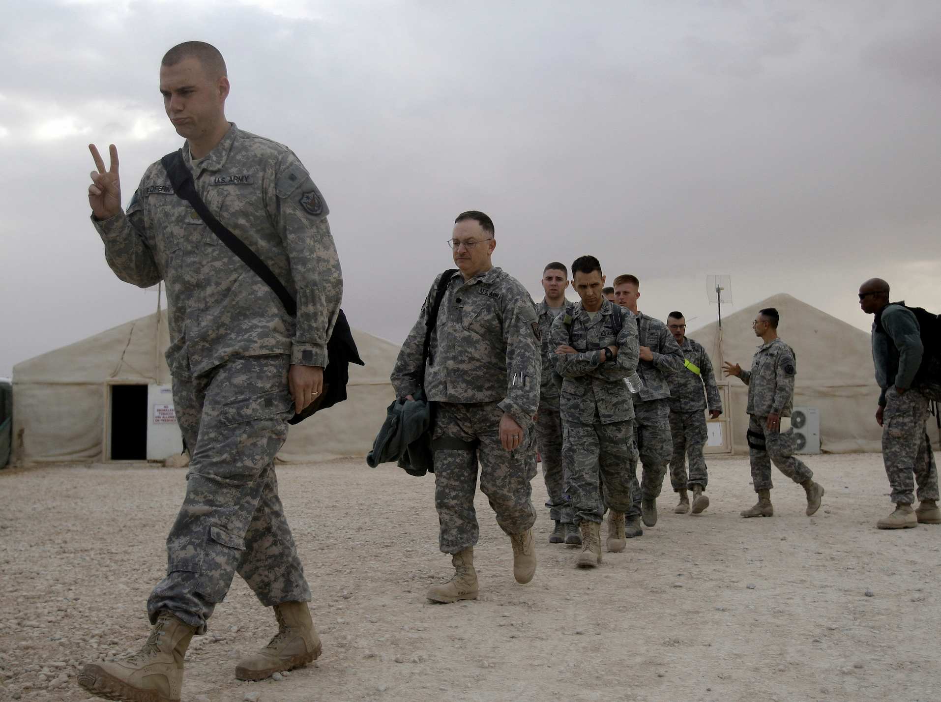 FILE - A U.S. army soldier flashes a V for victory sign as he begins his journey home, at the al-Asad Air Base west of Baghdad, Iraq, Nov. 1 , 2011. (AP Photo/Khalid Mohammed, File)