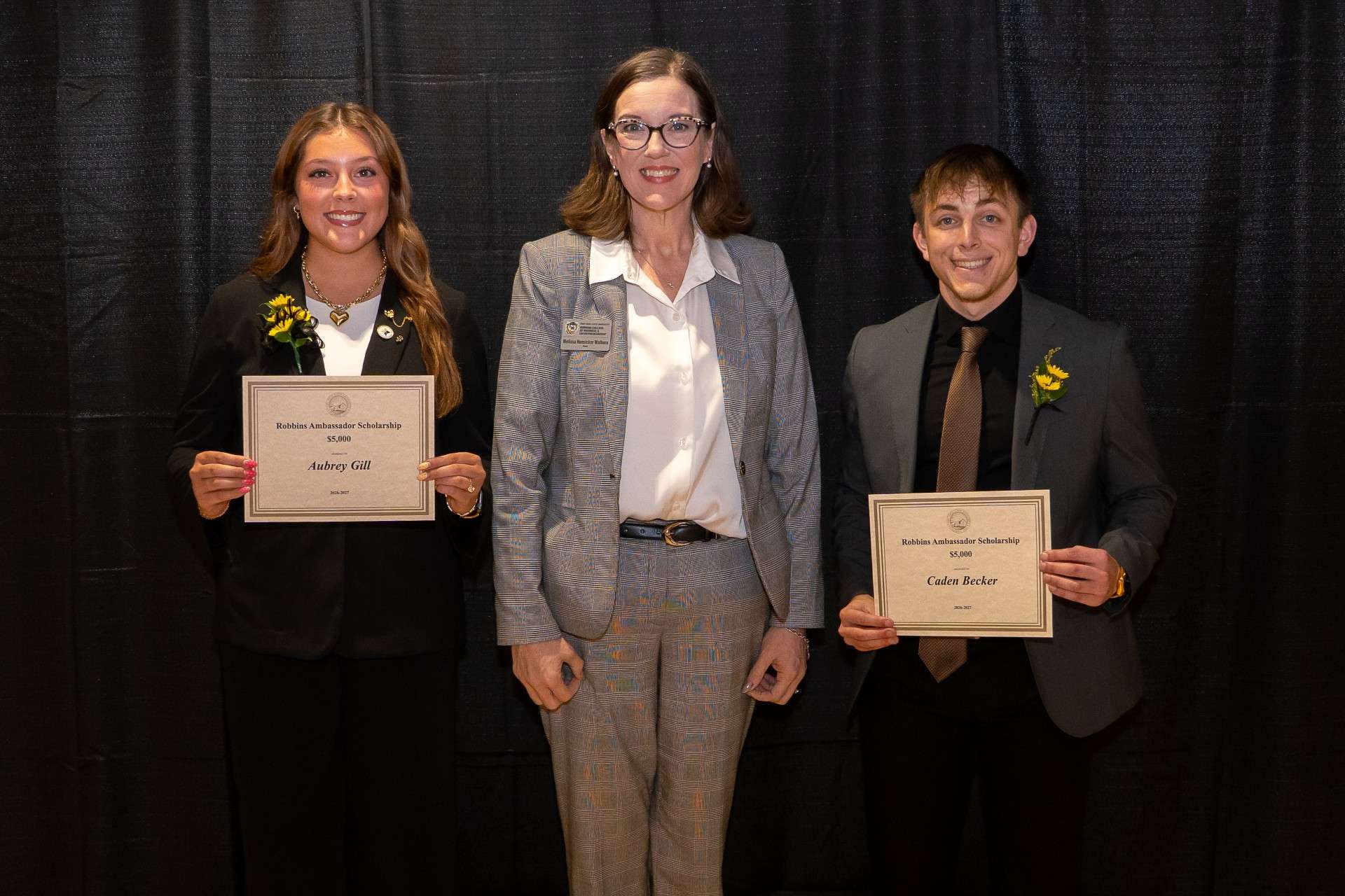 Robbins Ambassadors Aubrey Gill and Caden Becker accepted their scholarship awards from Fort Hays State University RCOBE Dean Melissa Hunsicker-Walburn. Photo courtesy FHSU