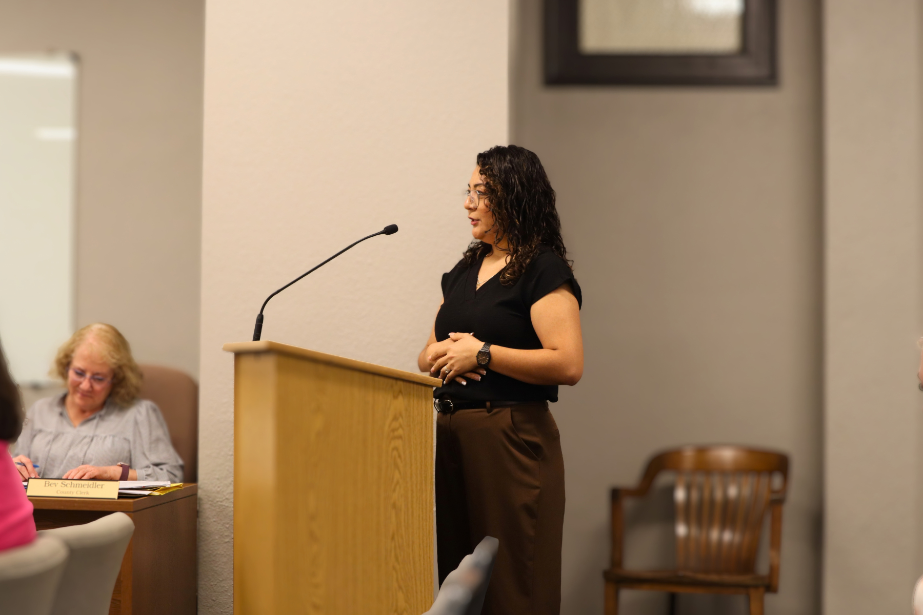 Rocio Hernandez, Domestic and Sexual Violence Program Director with the Family Crisis Center, presents the National Domestic Violence Awareness Month proclamation to the Barton County Commission.